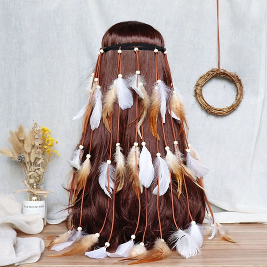 Boho bohemian macramé hair band (worn on long dark brown hair) featuring abundant white feather tassels, wooden bead accents, displayed with dried flower vase & woven wreath decor (against a light fabric background), ideal for bohemian festival fashion styling in the US 01