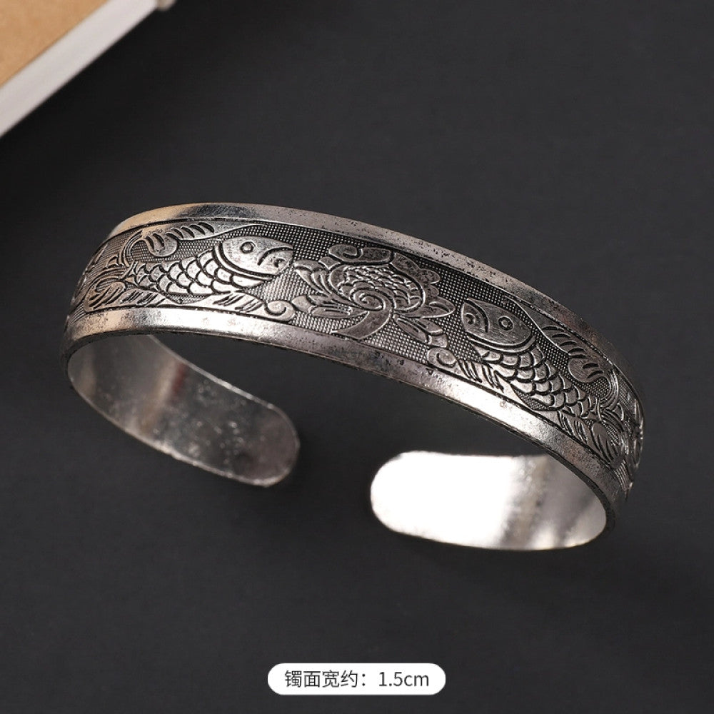 Vintage boho chic silver-tone filigree cuff bracelet with intricate floral designs, styled on a black surface, perfect for bohemian and ethnic fashion lovers in the US 02