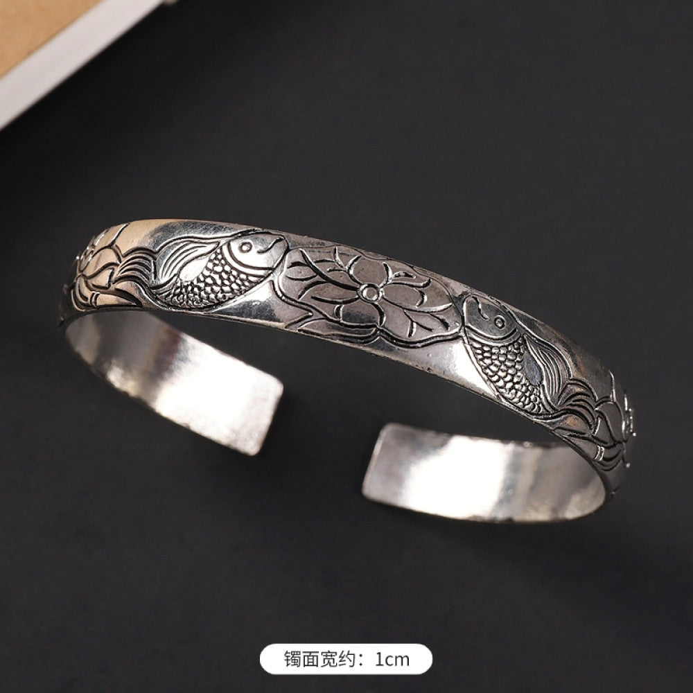Vintage boho chic silver-tone filigree cuff bracelet with intricate floral designs, styled on a black surface, perfect for bohemian and ethnic fashion lovers in the US 05