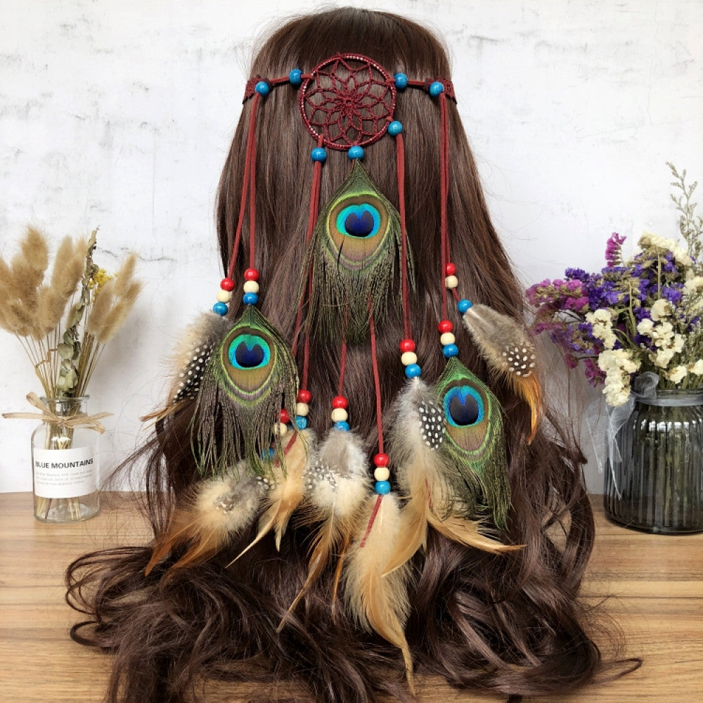Boho leather cord hair band featuring a vibrant peacock feather, multi color feather tassels, and bead accents displayed on a wooden surface with dried fresh flower arrangements, ideal for bohemian festival fashion enthusiasts in the US 01