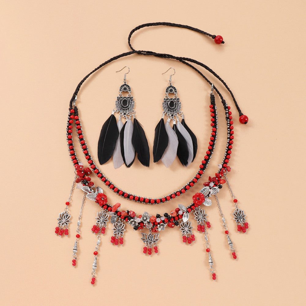 Boho red black braided cord choker necklace featuring red bead accents, intricate silver decorative tassel pendants, and adjustable red bead drawstring closure, displayed on a light yellow background, ideal for bohemian and trendy fashion styling in the US 01