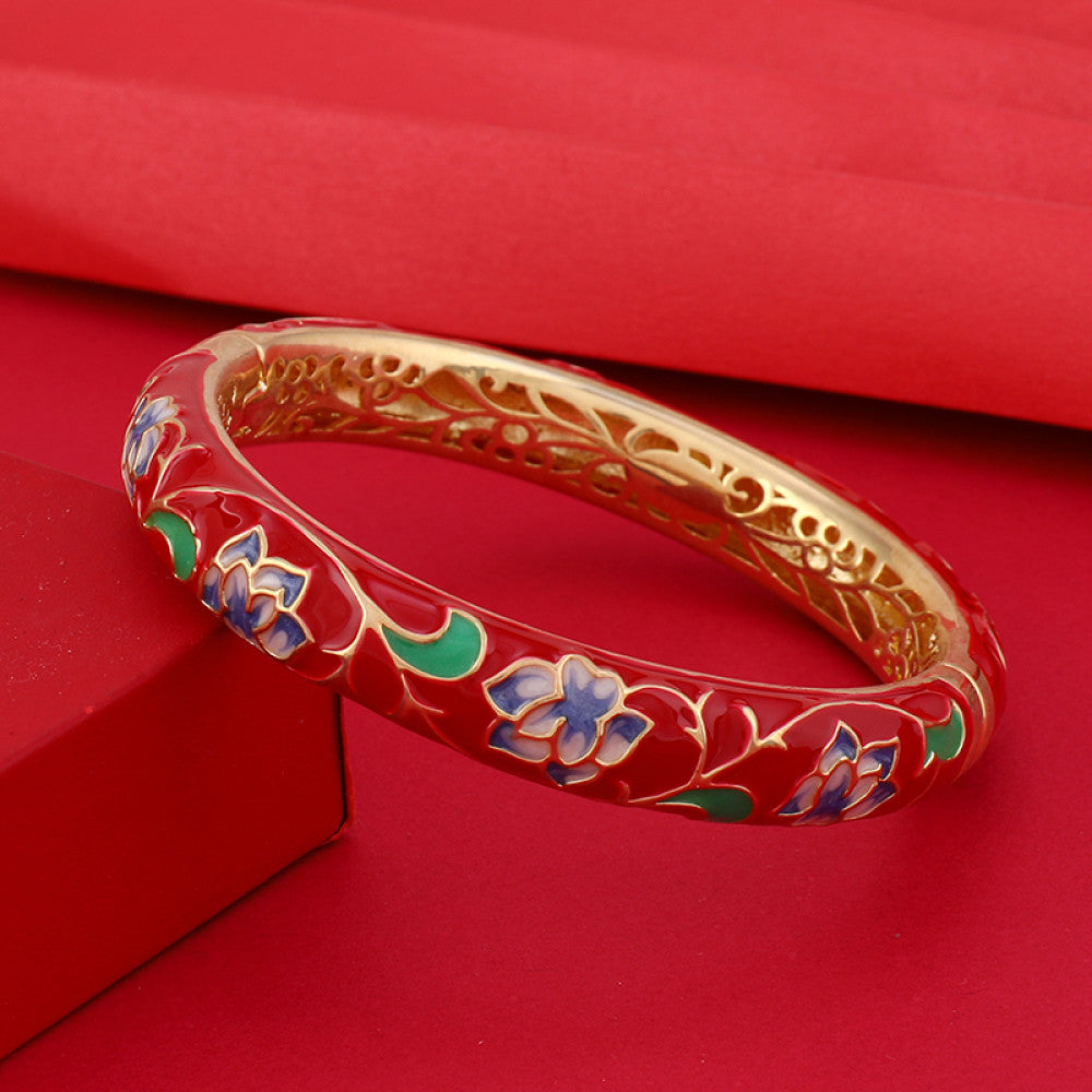 Boho vintage Chinese cloisonné enamel bangle with pink floral design and gold plating, styled on red background, ideal for ethnic and bohemian fashion enthusiasts in the US 01