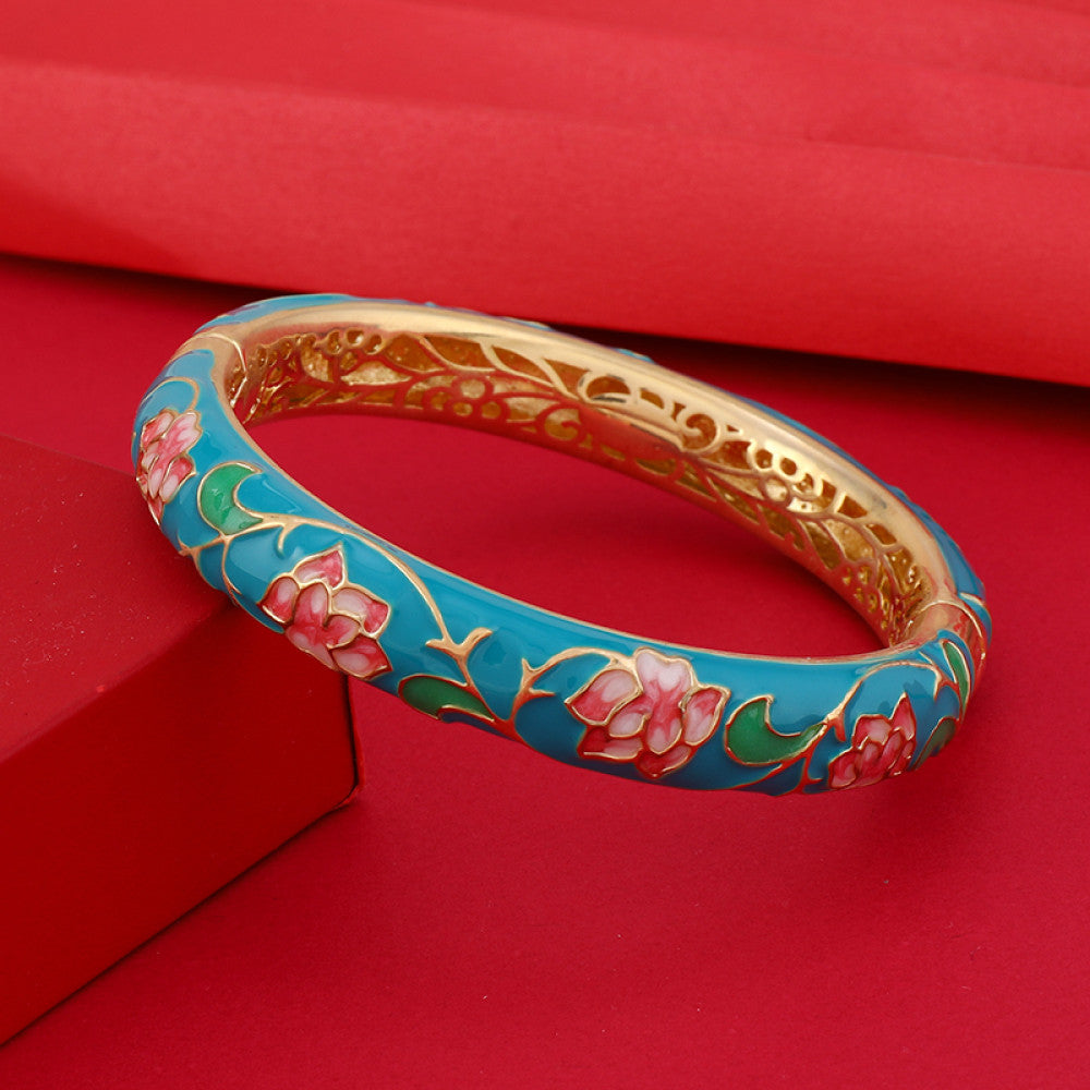 Boho vintage Chinese cloisonné enamel bangle with pink floral design and gold plating, styled on red background, ideal for ethnic and bohemian fashion enthusiasts in the US 02