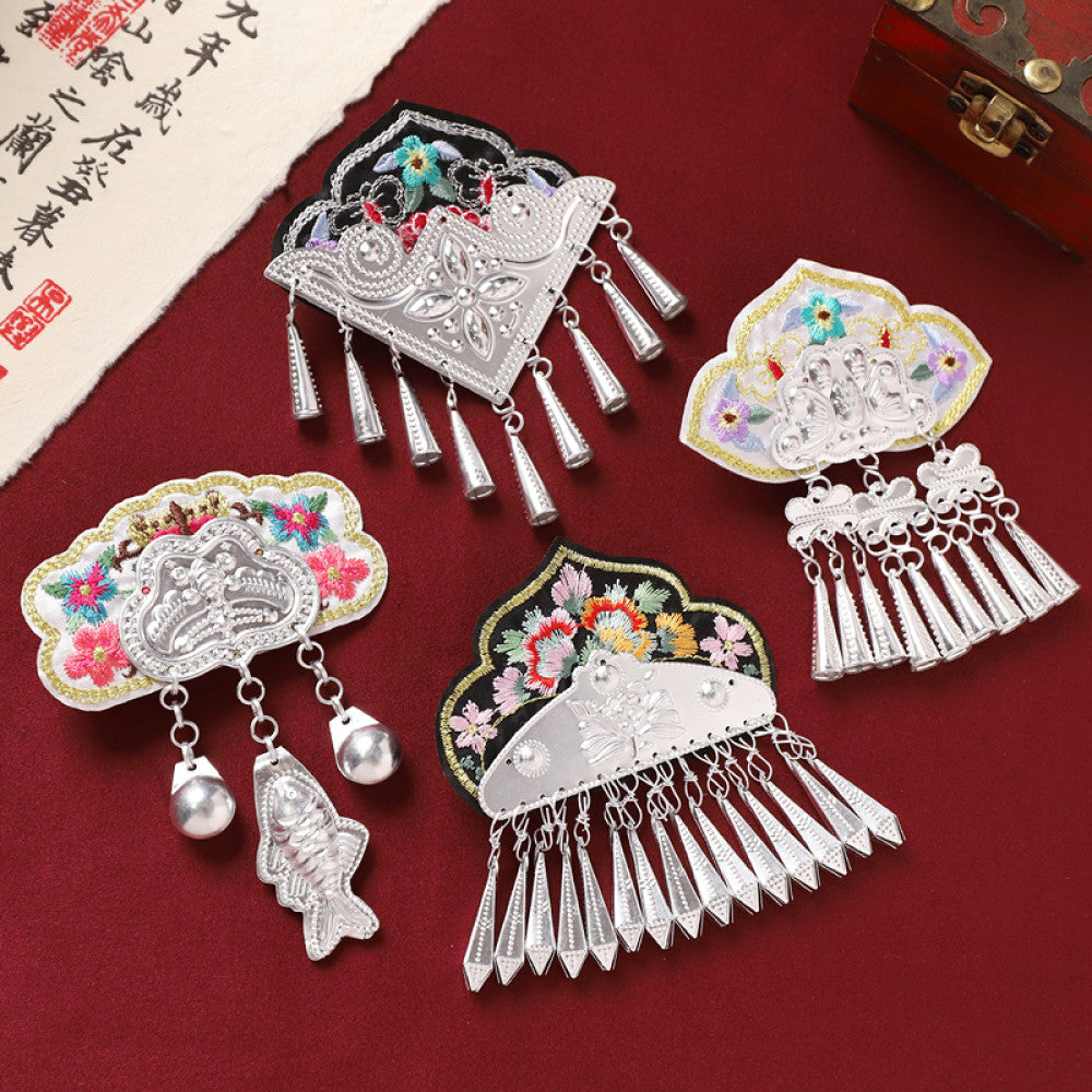 Set of 4 boho vintage ethnic decorative ornaments, featuring colorful embroidered accents, silver-tone charms (butterfly, fish), and tassel/bell pendants, displayed on a red fabric background (alongside calligraphy paper & a wooden box), ideal for bohemian and traditional fashion styling in the US