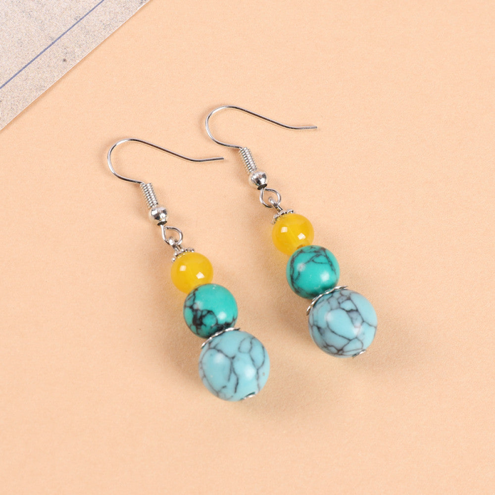 Pair of boho vintage ethnic dangle earrings (displayed on a soft beige background) featuring layered yellow and turquoise stone beads, ideal for bohemian casual fashion styling in the US