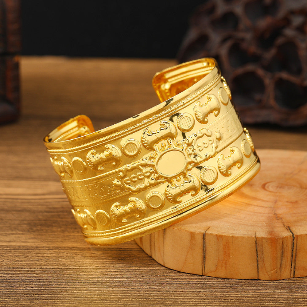 Boho vintage ethnic engraved gold cuff bangle with geometric designs, styled on wooden surface, ideal for bohemian and tribal fashion enthusiasts 01
