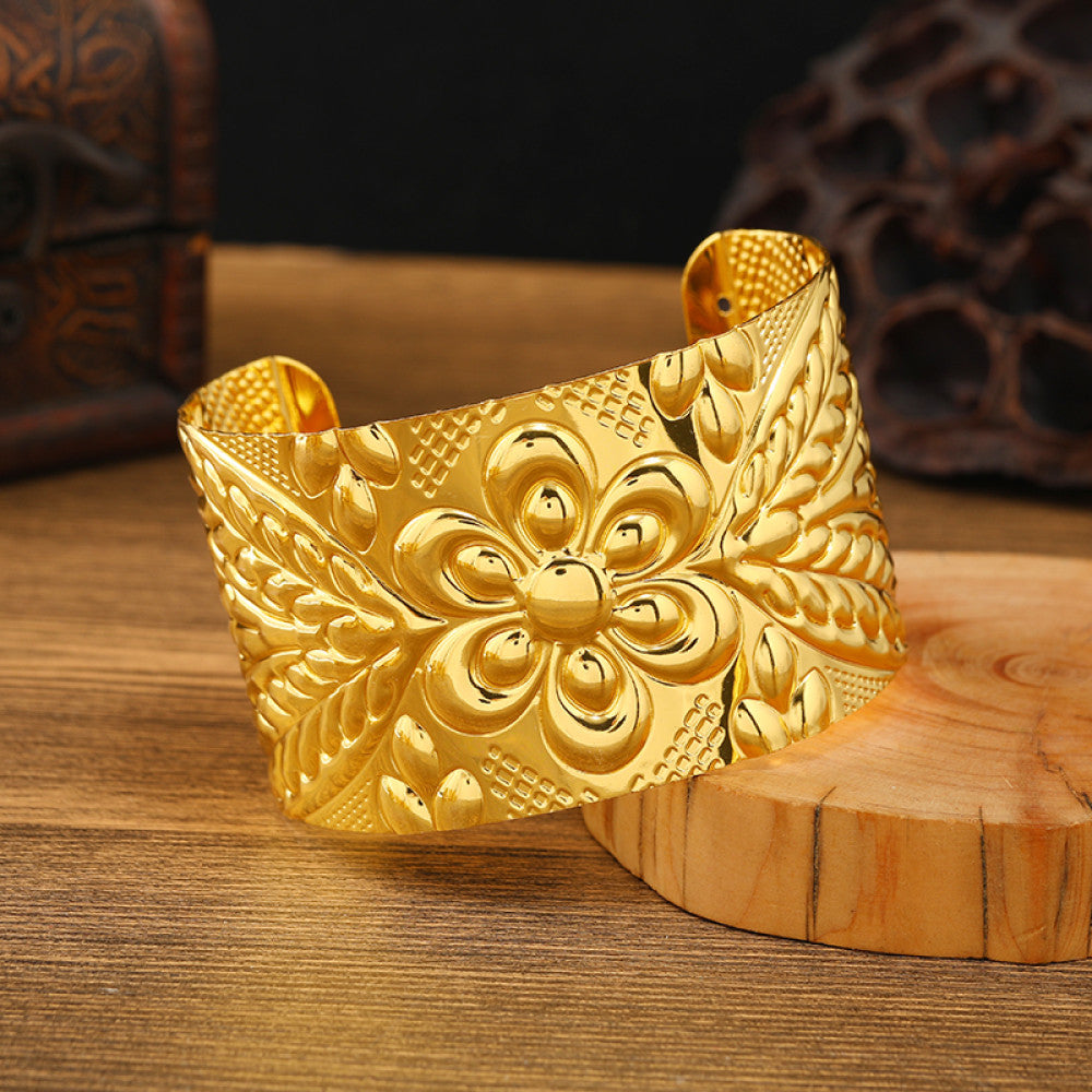 Boho vintage ethnic engraved gold cuff bangle with geometric designs, styled on wooden surface, ideal for bohemian and tribal fashion enthusiasts 05
