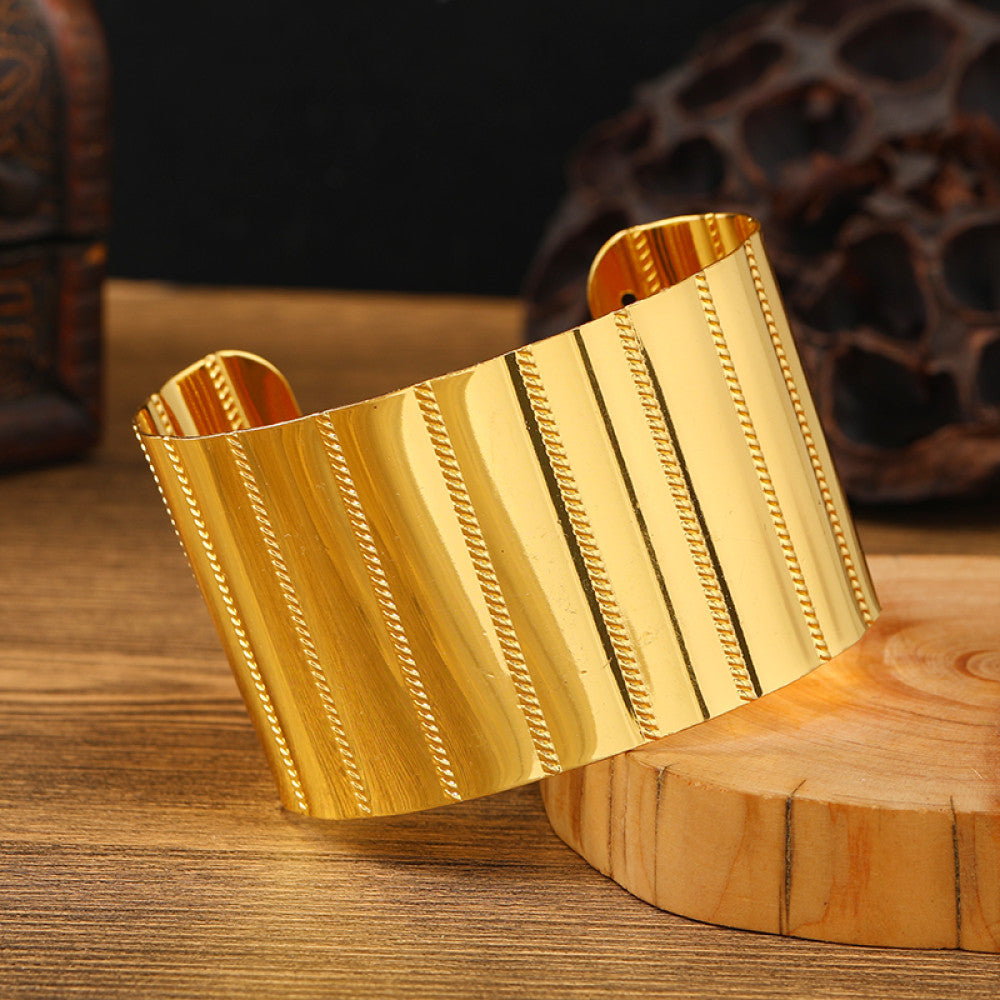Boho vintage ethnic engraved gold cuff bangle with geometric designs, styled on wooden surface, ideal for bohemian and tribal fashion enthusiasts 07