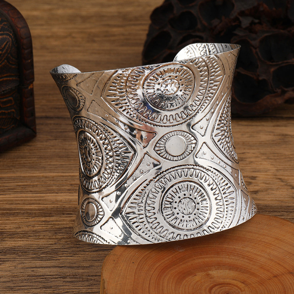 Boho vintage ethnic engraved silver cuff bangle with intricate floral designs, styled on wooden surface, ideal for bohemian and tribal fashion enthusiasts in the US 01