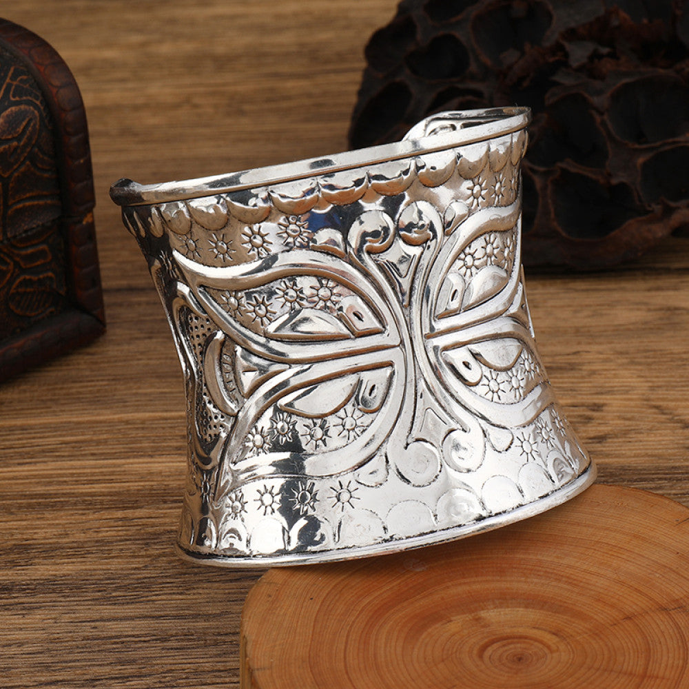 Boho vintage ethnic engraved silver cuff bangle with intricate floral designs, styled on wooden surface, ideal for bohemian and tribal fashion enthusiasts in the US 04