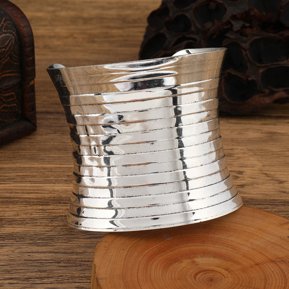 Boho vintage ethnic engraved silver cuff bangle with intricate floral designs, styled on wooden surface, ideal for bohemian and tribal fashion enthusiasts in the US 09