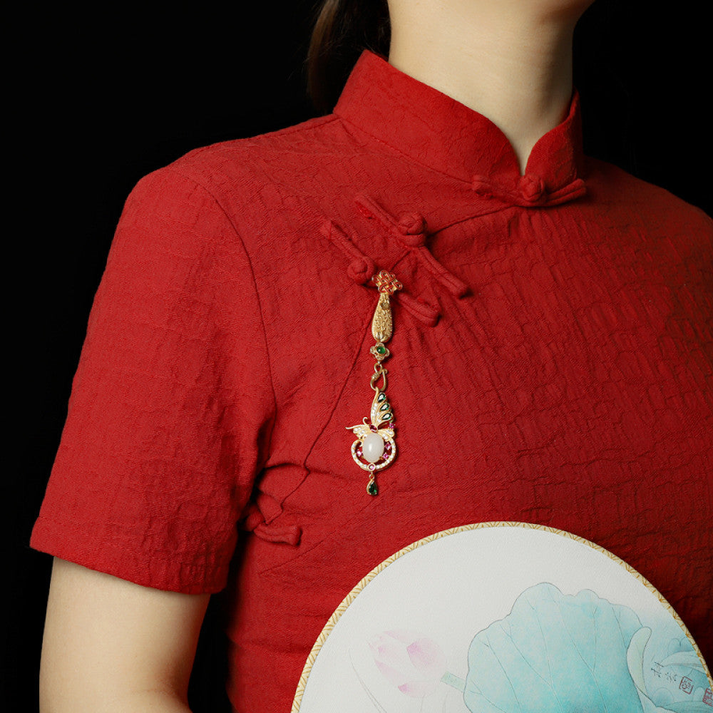 Boho vintage ethnic gold statement pendant featuring Chinese knot, peacock charm and colorful gemstone accents, styled on a tree branch, ideal for bohemian and traditional fashion enthusiasts in the US 01