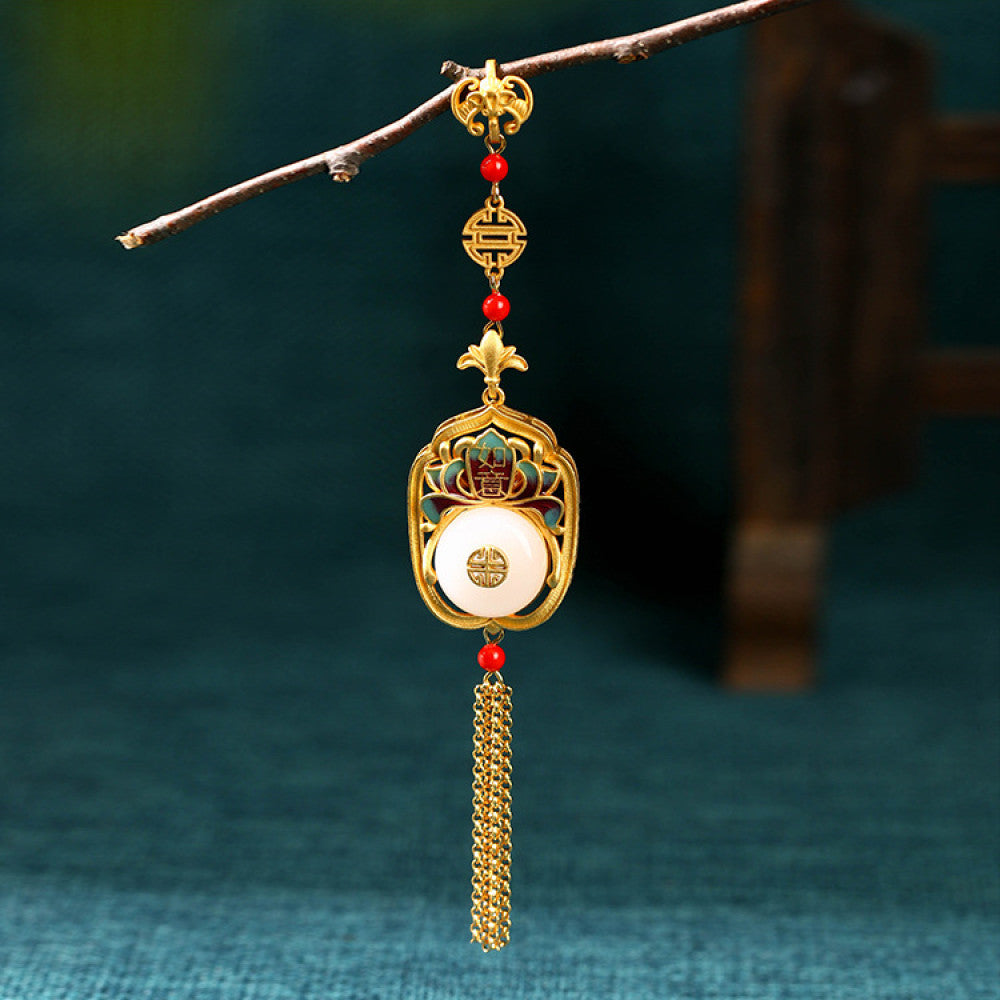 Boho vintage ethnic gold statement pendant featuring fu character, colorful enamel details, white gemstone center and gold tassel, styled on a tree branch, ideal for bohemian and traditional fashion enthusiasts in the US