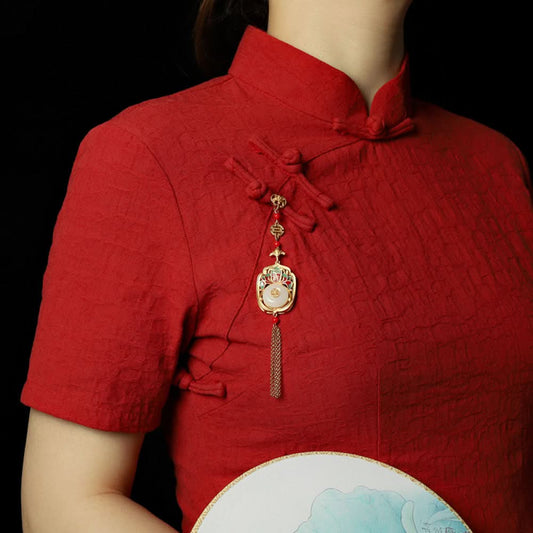 Boho vintage ethnic gold statement pendant featuring fu character, colorful enamel details, white gemstone center and gold tassel, styled on a tree branch, ideal for bohemian and traditional fashion enthusiasts in the US 01