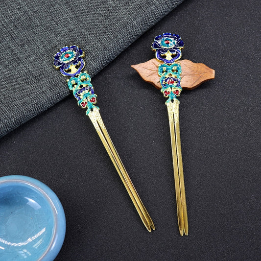 Pair of boho vintage ethnic gold-tone double hair sticks, featuring vibrant colorful enamel and gemstone accents, displayed on a dark fabric background