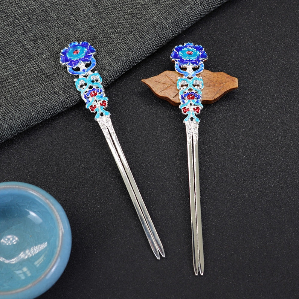 Pair of boho vintage ethnic gold-tone double hair sticks, featuring vibrant colorful enamel and gemstone accents, displayed on a dark fabric background 01