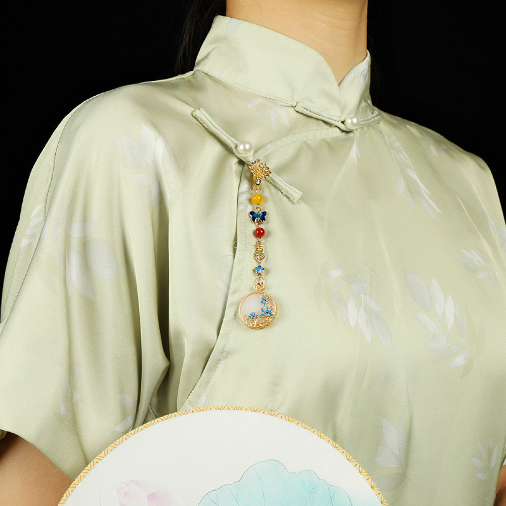 Boho vintage ethnic gold-tone hair pendant featuring butterfly decorative accent, Fu character detail, yellow/red/blue bead accents, and a white circular pendant with blue decorative detailing, styled on a wooden display hook against a black background, ideal for bohemian and traditional fashion enthusiasts in the US 01