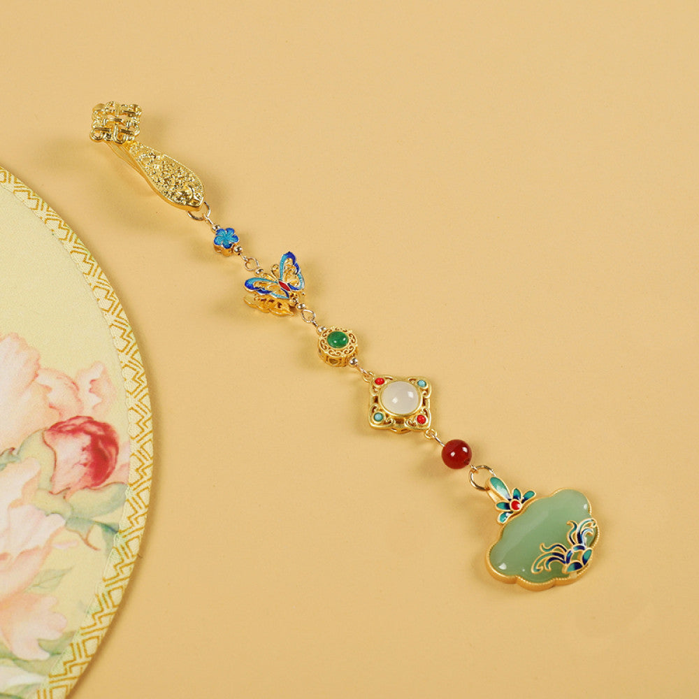 Boho vintage ethnic gold-tone hair pendant featuring multi-color gemstone (blue/green/red) accents, intricate enamel decorations, and a jade-inlaid ruyi lock-shaped pendant, styled on a wooden display hook against a black background, ideal for bohemian and traditional fashion enthusiasts in the US 03