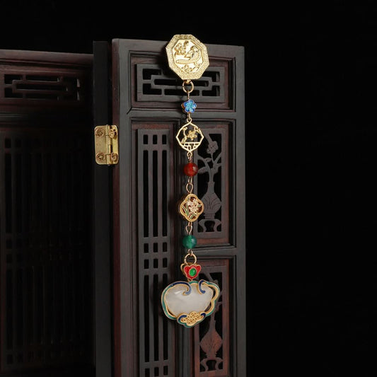 Boho vintage ethnic gold-tone hair pendant featuring intricate gold decorative clasp, blue/red/green gemstone accents, and an enamel-inlaid lock pendant with white texture, styled on a wooden display hook against a black background, ideal for bohemian and traditional fashion enthusiasts in the US 03