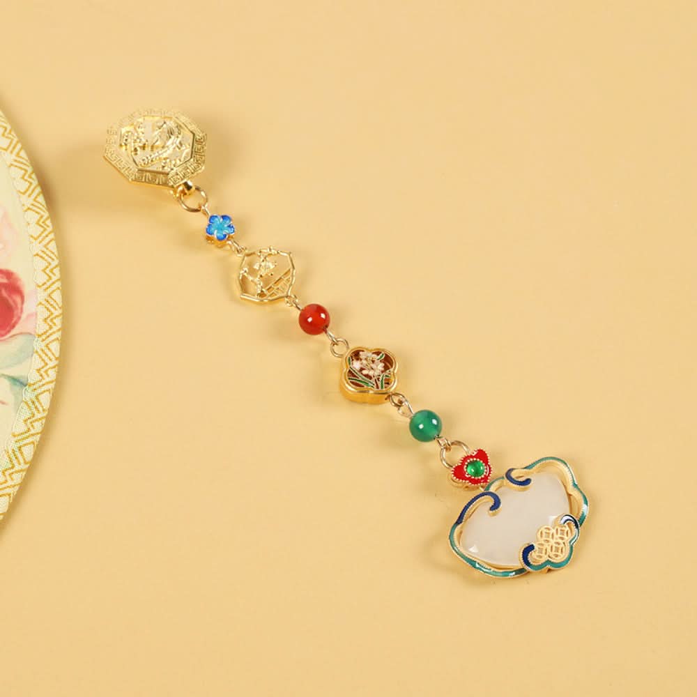 Boho vintage ethnic gold-tone hair pendant featuring intricate gold decorative clasp, blue/red/green gemstone accents, and an enamel-inlaid lock pendant with white texture, styled on a wooden display hook against a black background, ideal for bohemian and traditional fashion enthusiasts in the US 05