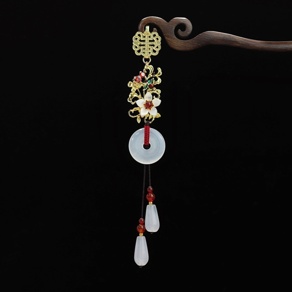 Boho vintage ethnic gold-tone hair pendant featuring double happiness charm, colorful floral details, white jade pendant and red bead tassels, styled on a wooden display hook, ideal for bohemian and traditional fashion enthusiasts in the US