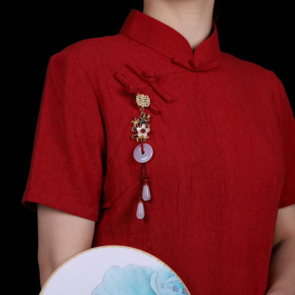 Boho vintage ethnic gold-tone hair pendant featuring double happiness charm, colorful floral details, white jade pendant and red bead tassels, styled on a wooden display hook, ideal for bohemian and traditional fashion enthusiasts in the US 01