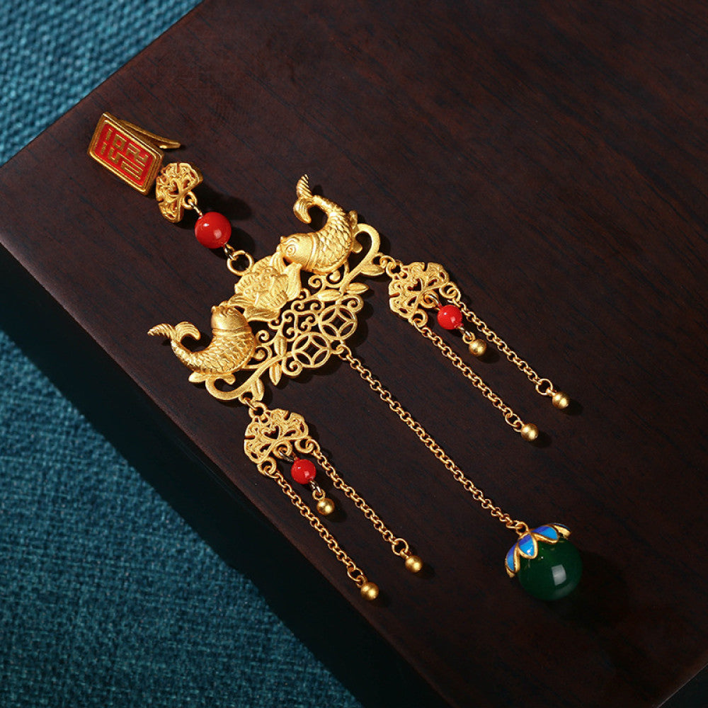 Boho vintage ethnic gold-tone hair pendant featuring red double happiness charm, intricate gold decorative details, red bead accents and a green beaded pendant, styled on a twig against a teal background, ideal for bohemian and traditional fashion enthusiasts in the US 02