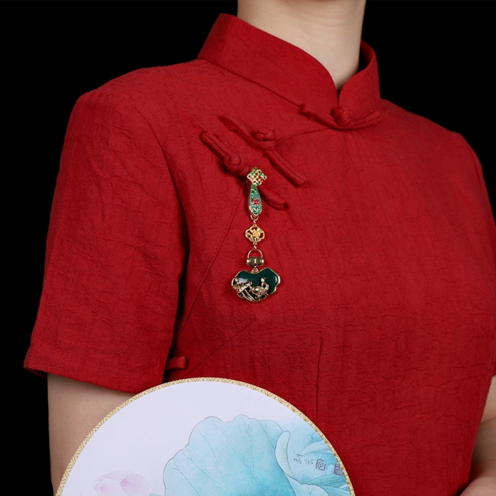 Boho vintage ethnic gold-tone hair pendant featuring green enamel accents, Chinese knot detail, and a carved green agate lock charm, styled on a wooden display hook, ideal for bohemian and traditional fashion enthusiasts in the US 01