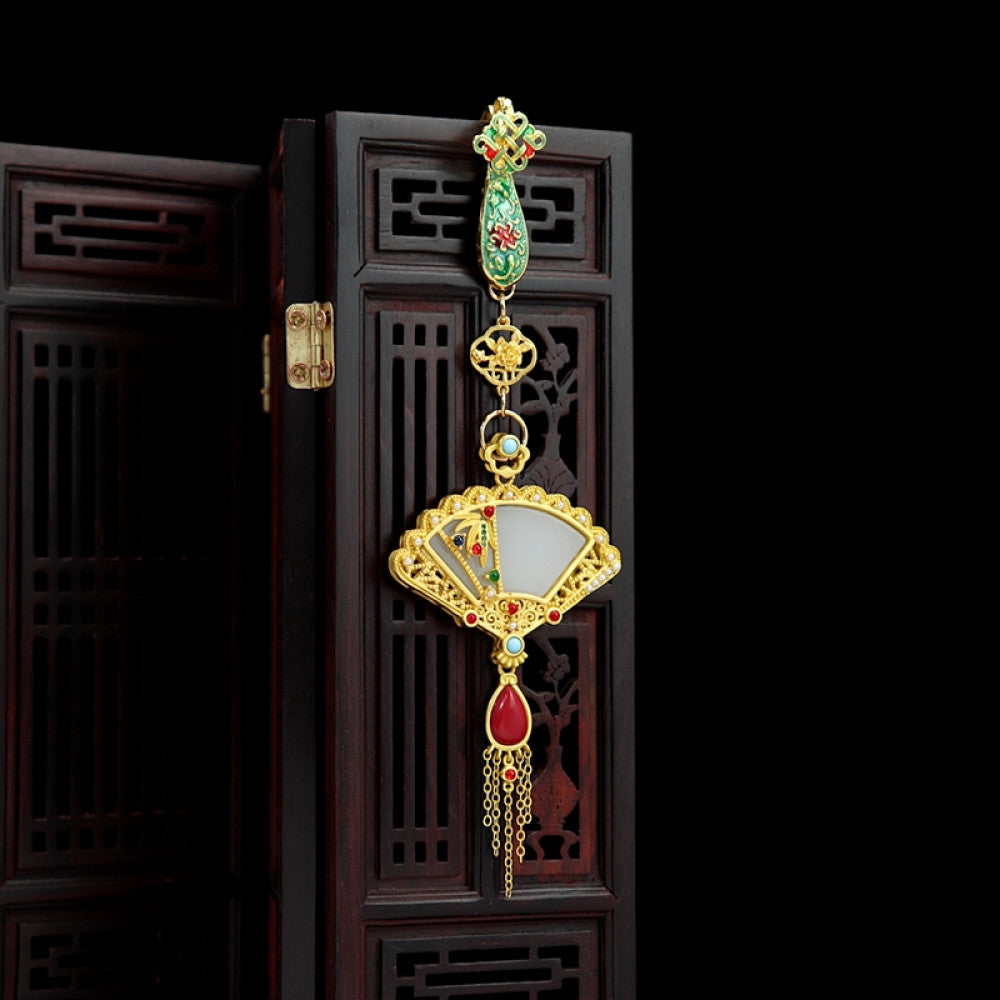 Boho vintage ethnic gold-tone hair pendant featuring green enamel detail, fan-shaped white shell charm, red gemstone accents and delicate tassel, styled on a wooden display hook, ideal for bohemian and traditional fashion enthusiasts in the US 02