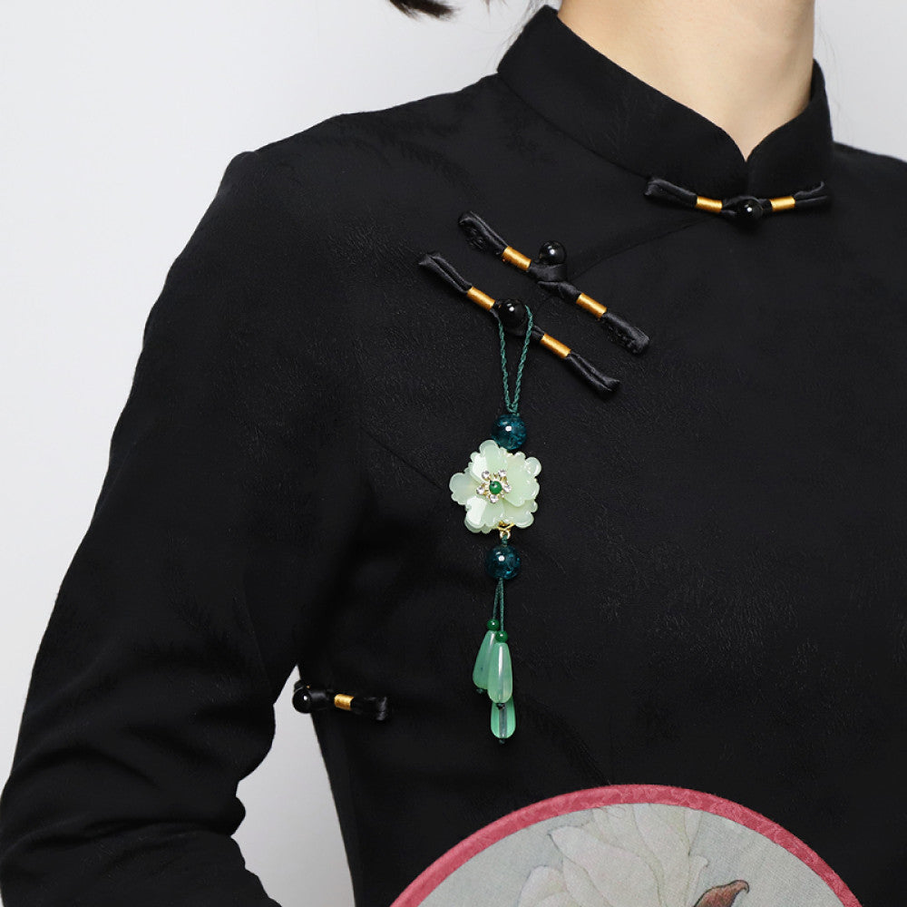 Boho vintage ethnic green-tone hair pendant featuring green cord, dark teal decorative beads, white flower charm (with gemstone center), and light green teardrop pendants, styled against a black fabric background, ideal for bohemian and traditional fashion enthusiasts in the US 02