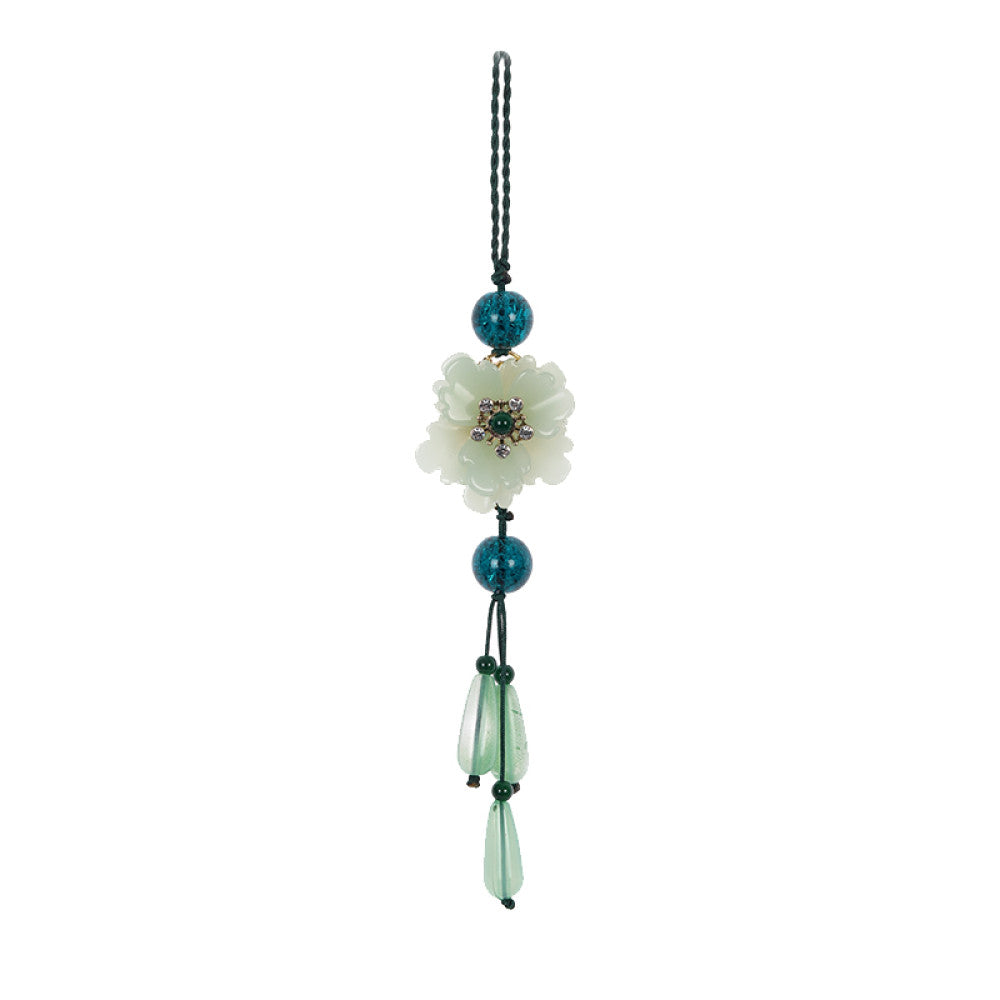Boho vintage ethnic green-tone hair pendant featuring green cord, dark teal decorative beads, white flower charm (with gemstone center), and light green teardrop pendants, styled against a black fabric background, ideal for bohemian and traditional fashion enthusiasts in the US 06
