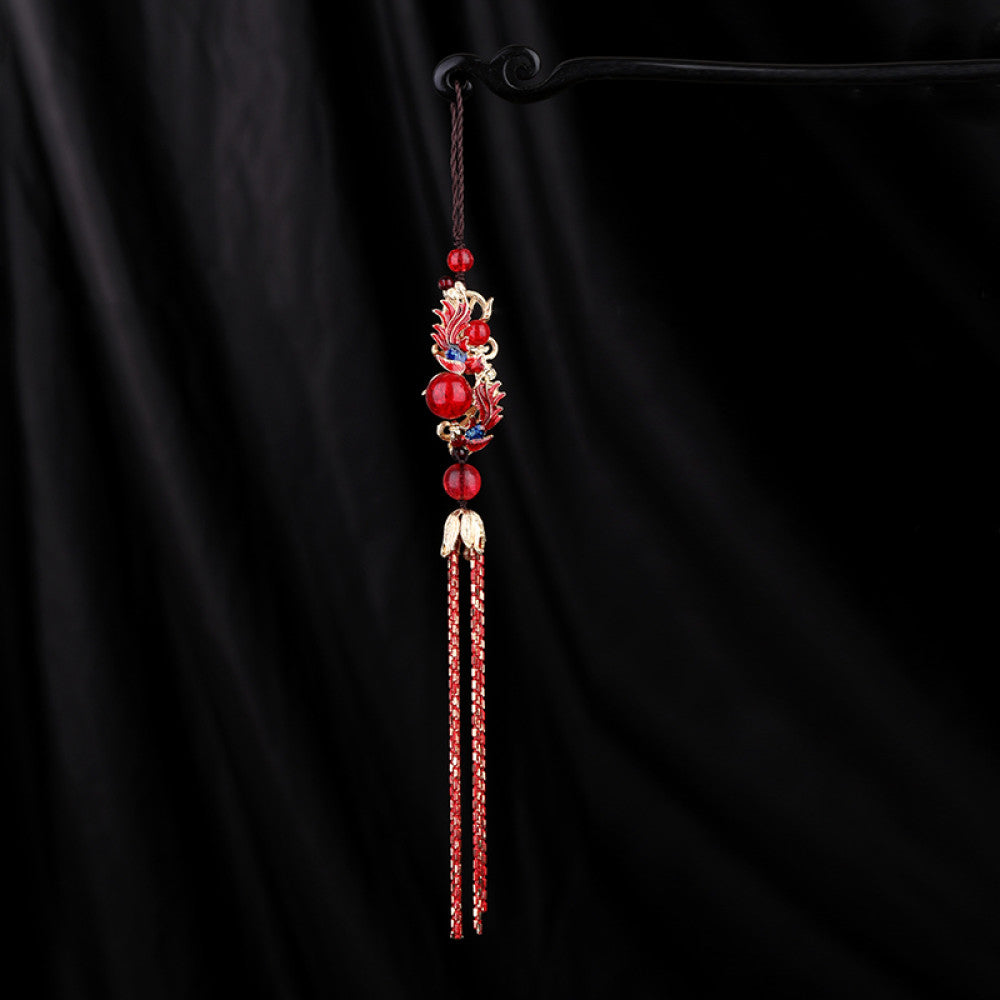 Boho vintage ethnic red-tone hair pendant featuring black cord, intricate red dragon charm (with decorative details), red bead accents, and long red-gold fringe tassels, styled against a black fabric background, ideal for bohemian and traditional fashion enthusiasts in the US
