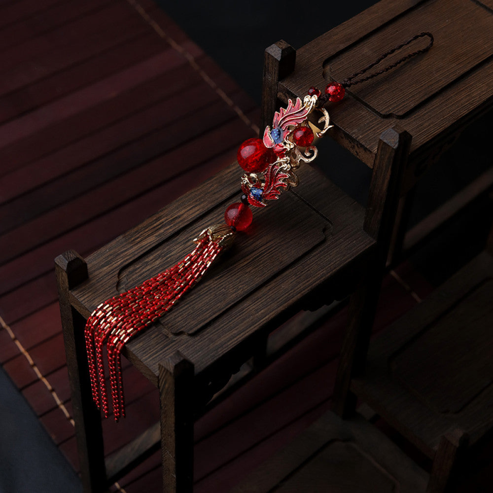 Boho vintage ethnic red-tone hair pendant featuring black cord, intricate red dragon charm (with decorative details), red bead accents, and long red-gold fringe tassels, styled against a black fabric background, ideal for bohemian and traditional fashion enthusiasts in the US 01