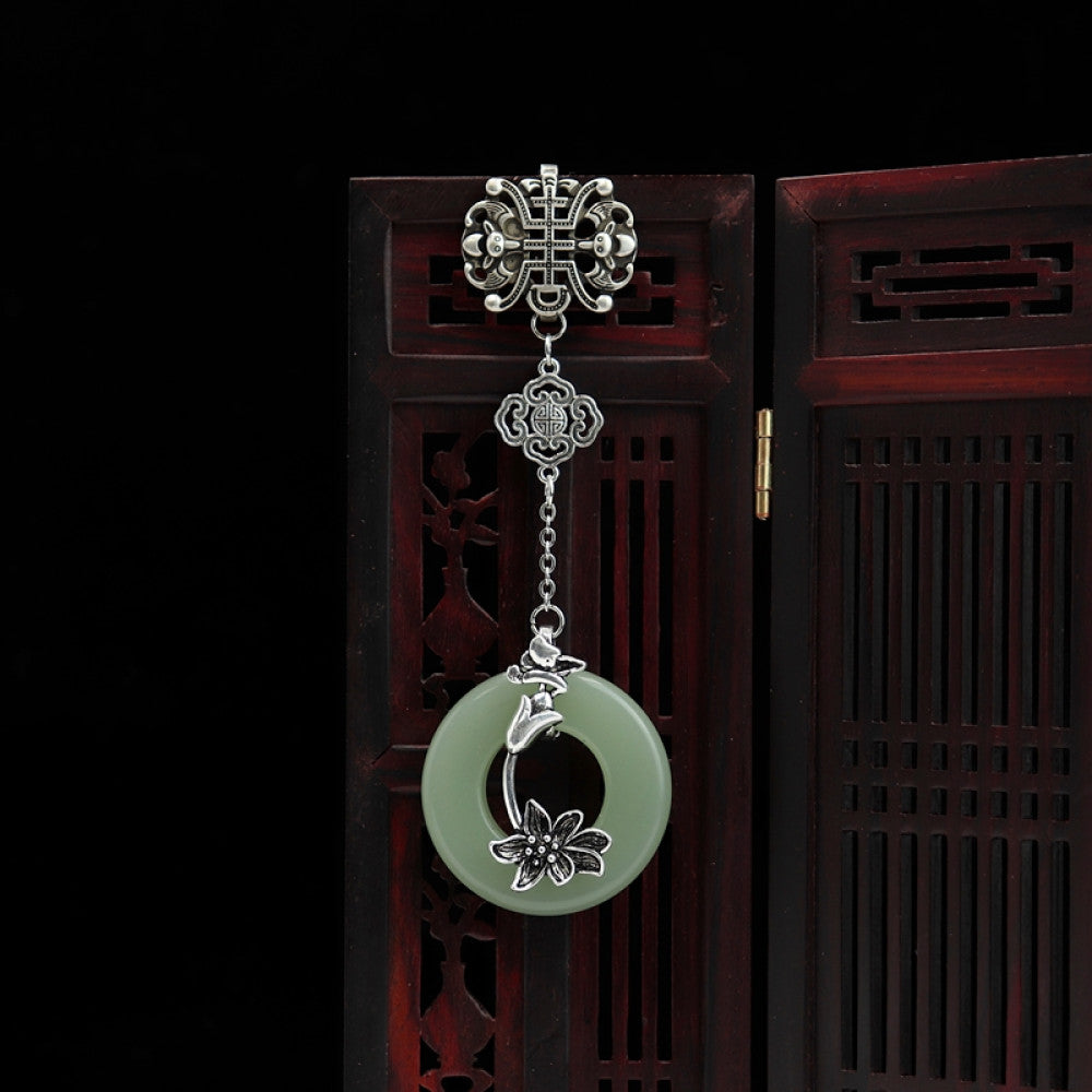Boho vintage ethnic silver hair pendant featuring Chinese knot detail, green jade ring with lotus carving, styled on a Chinese wooden frame, ideal for bohemian and traditional fashion enthusiasts in the US