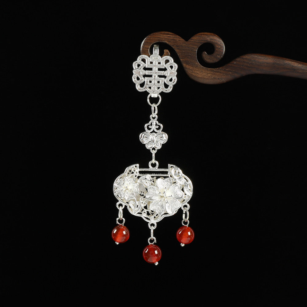 Boho vintage ethnic silver hair pendant featuring Chinese knot, intricate lantern charm and red bead details, styled on a wooden display hook, ideal for bohemian and traditional fashion enthusiasts in the US