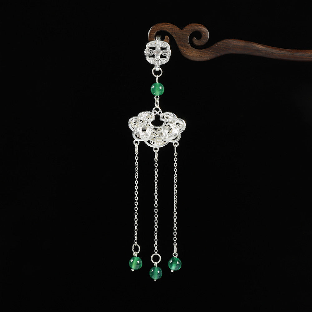 Boho vintage ethnic silver hair pendant with Chinese knot detail, intricate lock charm and red bead tassels, styled on a wooden display hook, ideal for bohemian and traditional fashion enthusiasts in the US 01