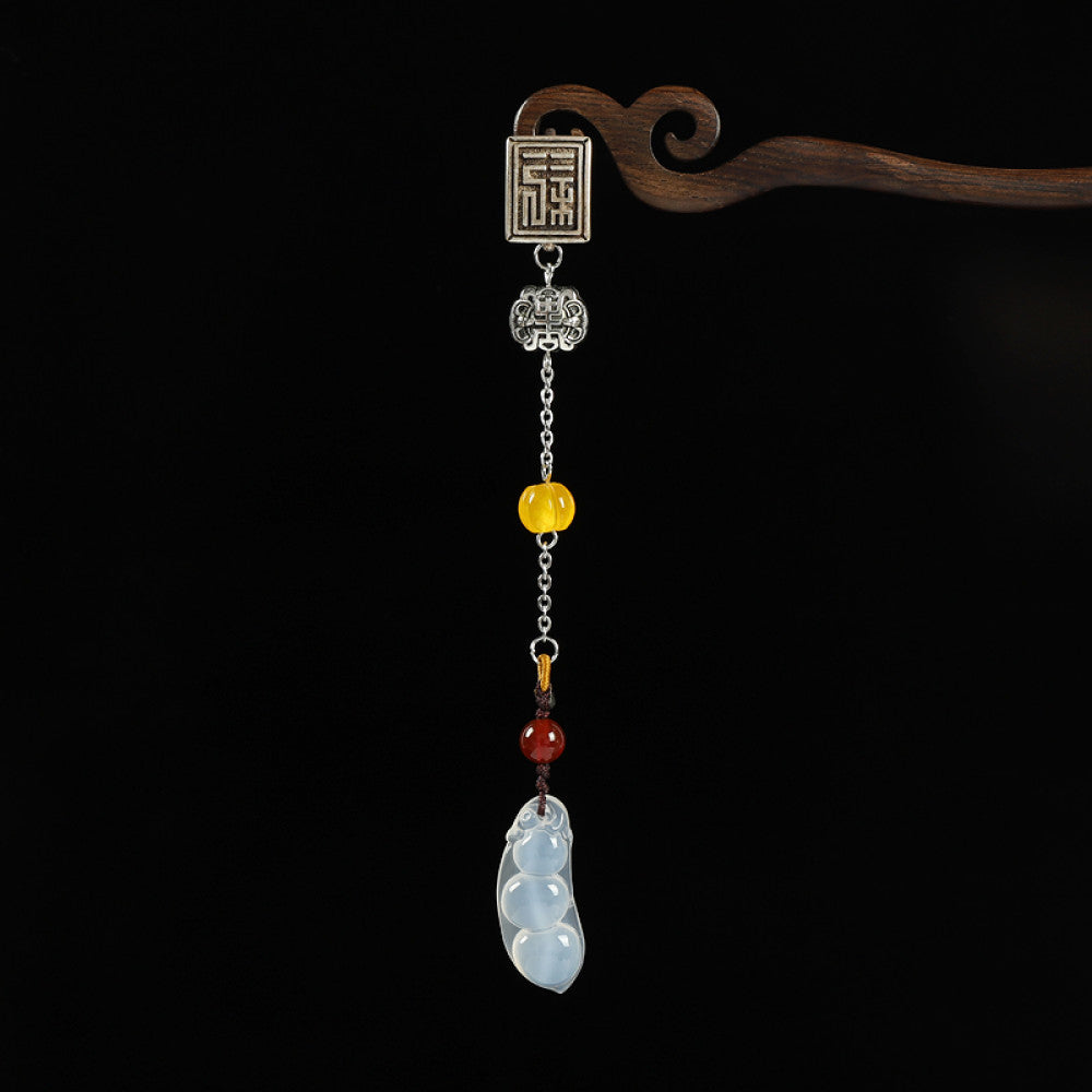Boho vintage ethnic silver hair pendant featuring Fu character detail, yellow/red bead accents, and a jade bean-shaped charm, styled on a wooden display hook against a black background, ideal for bohemian and traditional fashion enthusiasts in the US