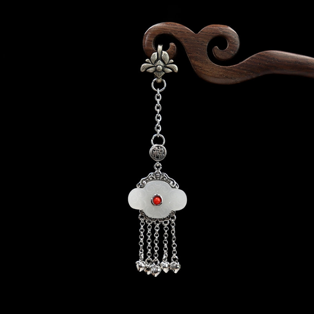 Boho vintage ethnic silver hair pendant featuring red gemstone center, clover-shaped white charm and silver tassel details, styled on a woo