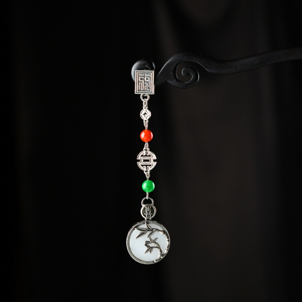 Boho vintage ethnic silver pendant charm featuring fu character, red & green beads, and a carved round plaque, styled on a display hook, ideal for bohemian and traditional fashion enthusiasts in the US