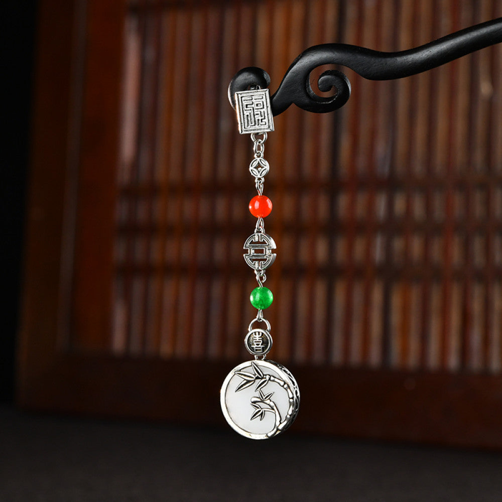 Boho vintage ethnic silver pendant charm featuring fu character, red & green beads, and a carved round plaque, styled on a display hook, ideal for bohemian and traditional fashion enthusiasts in the US 01
