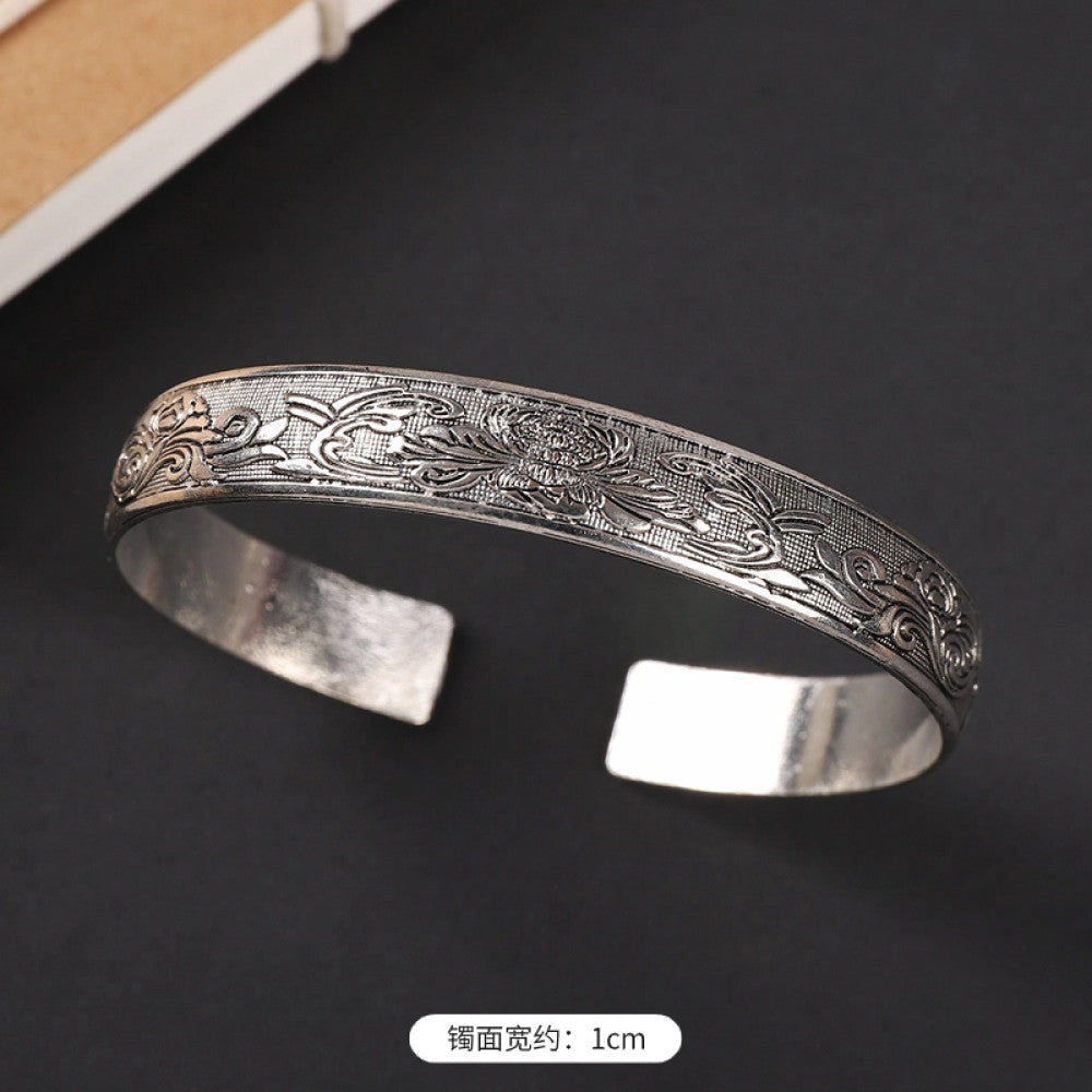 Vintage boho ethnic silver-tone cuff bracelet with dragon and phoenix engravings, styled on a black surface, ideal for bohemian and cultural fashion enthusiasts in the US 01