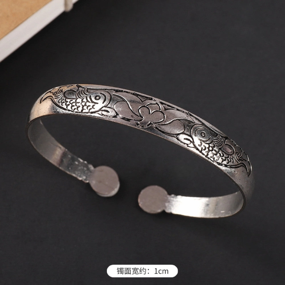 Vintage boho ethnic silver-tone cuff bracelet with dragon and phoenix engravings, styled on a black surface, ideal for bohemian and cultural fashion enthusiasts in the US 03