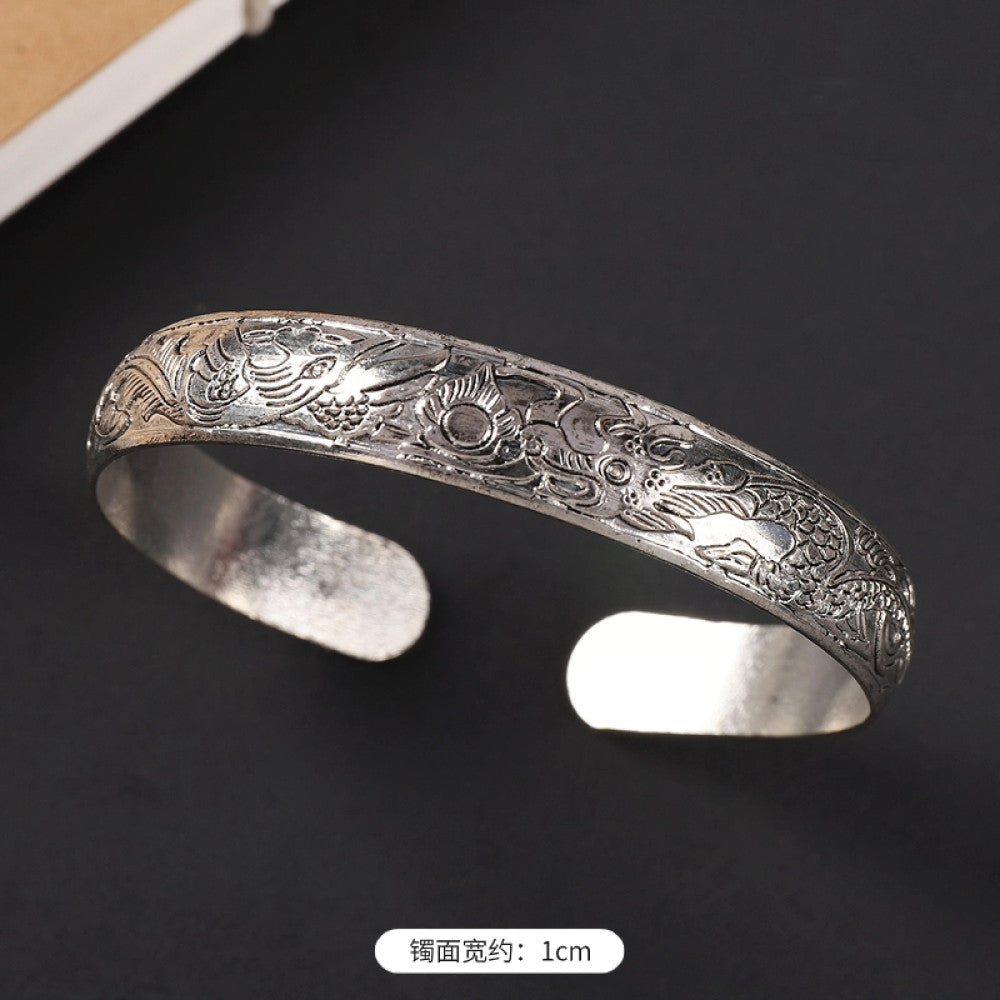 Vintage boho ethnic silver-tone cuff bracelet with dragon and phoenix engravings, styled on a black surface, ideal for bohemian and cultural fashion enthusiasts in the US 09