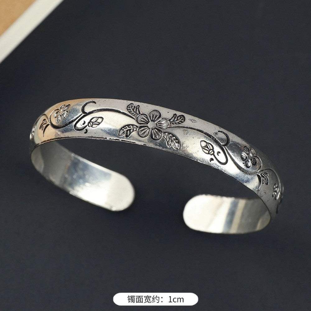 Vintage boho ethnic silver-tone cuff bracelet with dragon and phoenix engravings, styled on a black surface, ideal for bohemian and cultural fashion enthusiasts in the US 10