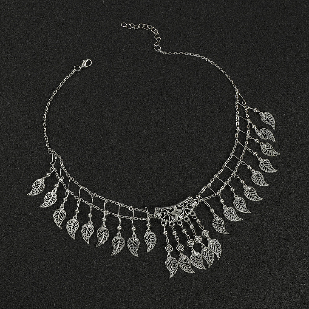 Boho vintage ethnic silver-tone hair clip ornament (displayed on a black background) featuring leaf-shaped dangle fringe and an ornate central decorative piece