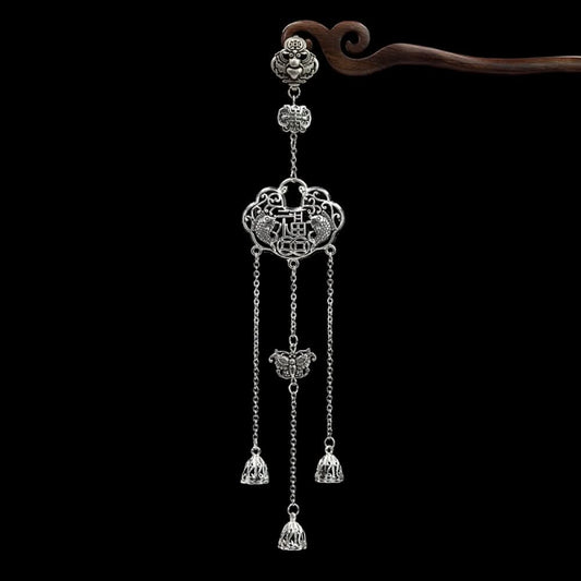 Boho vintage ethnic silver-tone hair pendant featuring Chinese knot charm, red gemstone accent, intricate openwork lock-shaped pendant and layered silver tassels, styled on a wooden display hook against a black background, ideal for bohemian and traditional fashion enthusiasts in the US 01