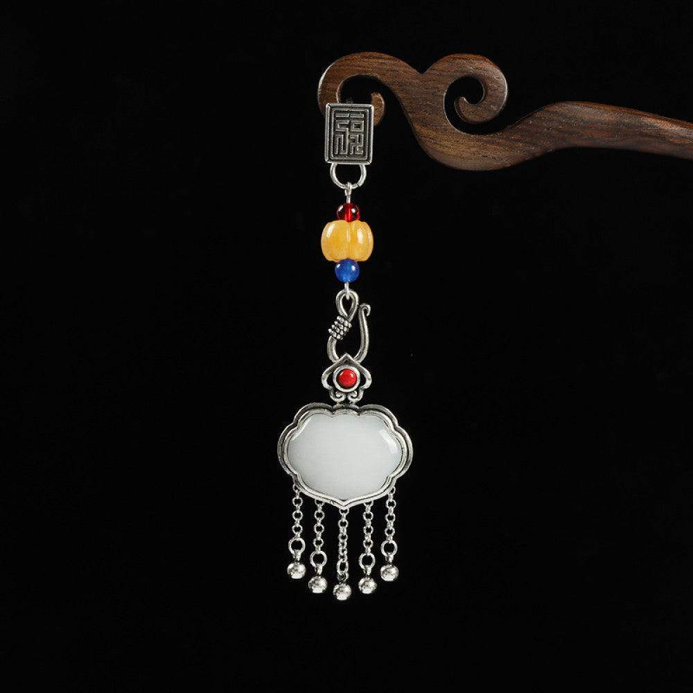 Boho vintage ethnic silver-tone hair pendant featuring Fu character detail, yellow/blue bead accents, red gemstone decoration, white lock-shaped pendant and silver tassel details, styled on a wooden display hook against a black background, ideal for bohemian and traditional fashion enthusiasts in the US