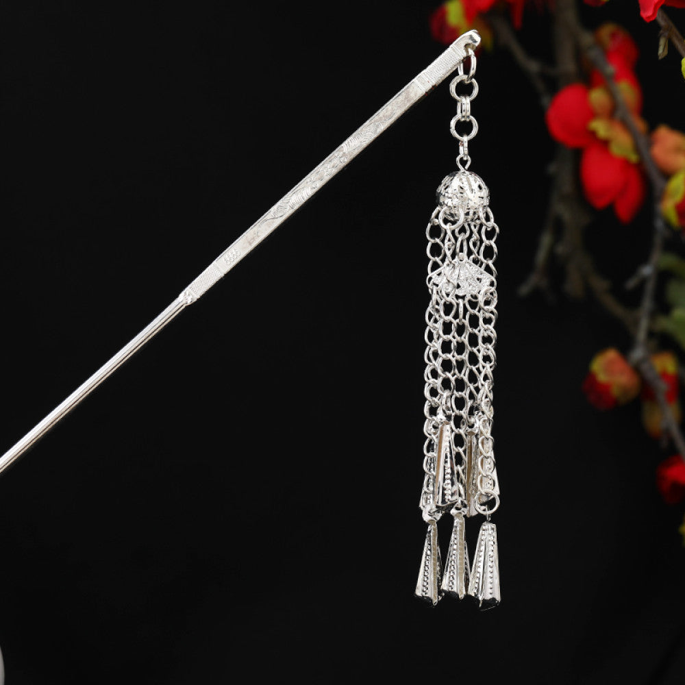 Boho vintage ethnic silver-tone hair stick featuring detailed textured handle, intricate chain network decor, and layered silver tassel pendants, displayed against a black background with red floral accents, ideal for bohemian and traditional fashion enthusiasts in the US