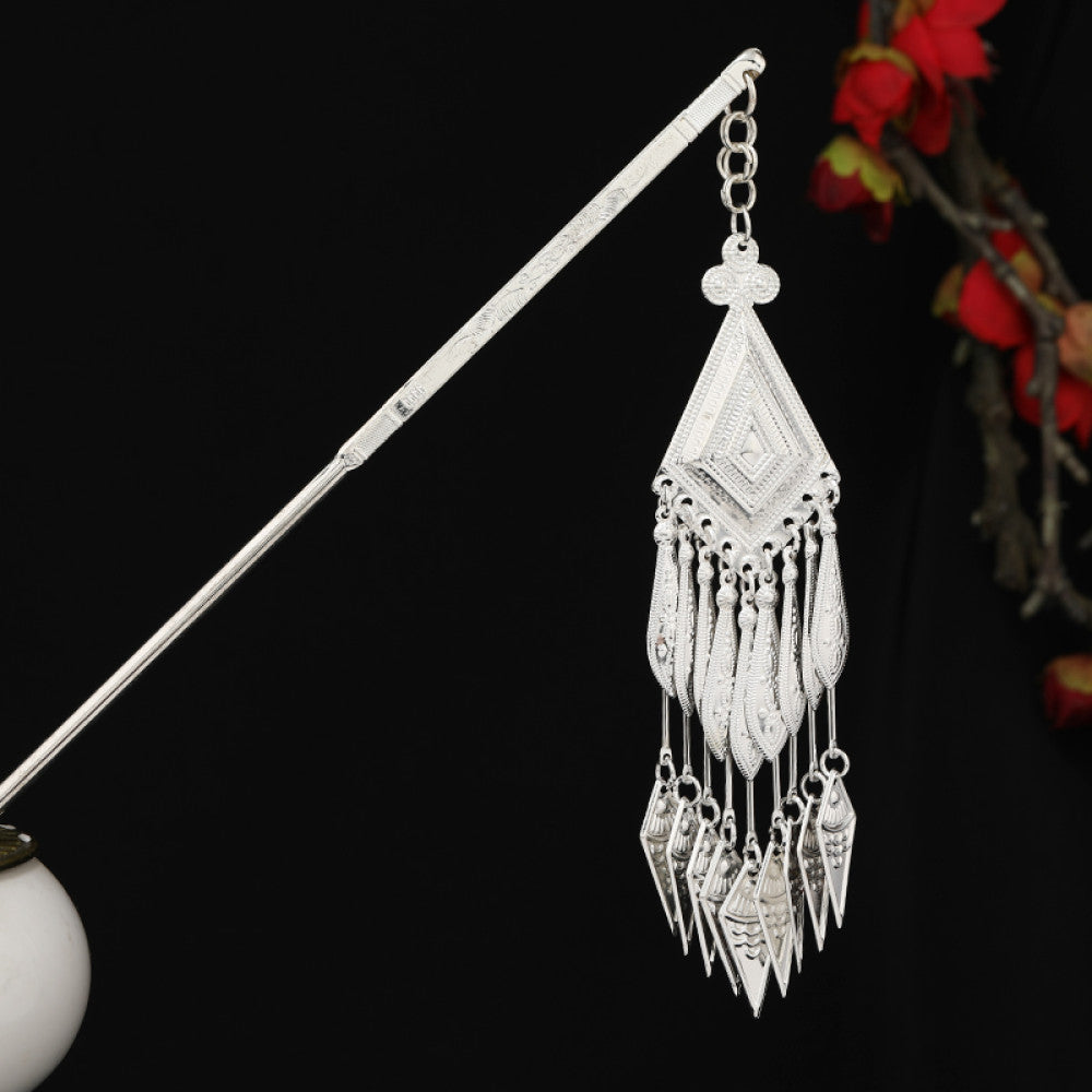 Boho vintage ethnic silver-tone hair stick featuring detailed textured handle, intricate chain network decor, and layered silver tassel pendants, displayed against a black background with red floral accents 13