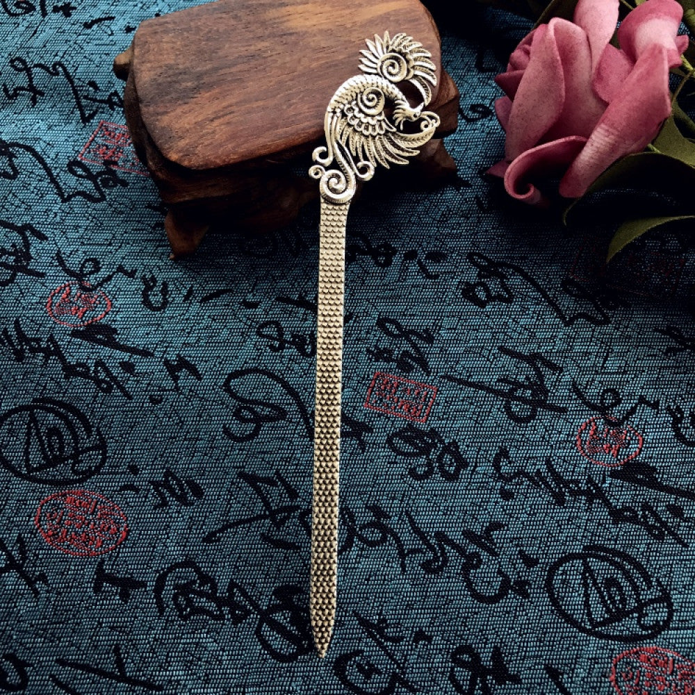 Boho vintage ethnic silver-tone hair stick featuring an intricate curved decorative top, displayed on a blue fabric with text patterns 02